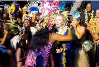 Mrs Clinton was garlanded with flowers as arrived in Rarotonga