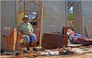 Mama amid her wrecked home